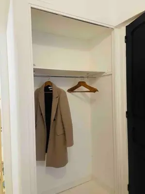 a closet with a coat and a suit in it at Le P'tit Stud' in Castres