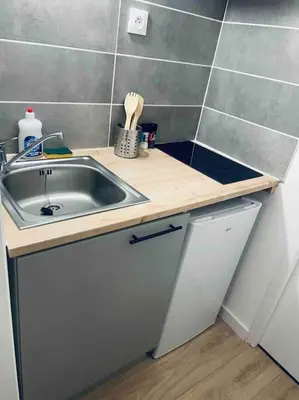 a kitchen with a sink and a counter top at Le P'tit Stud' in Castres