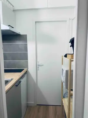 a white door in a kitchen with a sink at Le P'tit Stud' in Castres