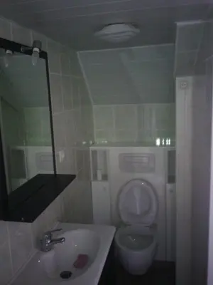 a bathroom with a toilet and a sink and a mirror at Le Cabanon in Lacrouzette