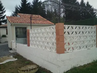 a fence in front of a house at Le Cabanon in Lacrouzette