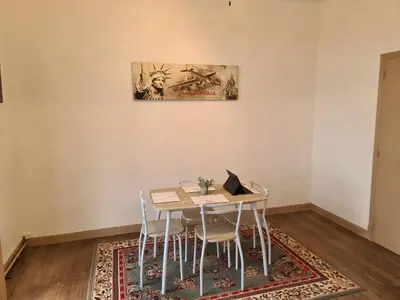 a dining room with a table with chairs and a laptop at Spacious Luxury 2 bed appartment in Carcassonne