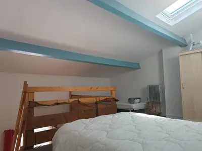a bedroom with a bed and a blue ceiling at Pavillon 5 personnes in Port-la-Nouvelle