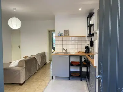 a living room with a table and a couch at T2 cosy avec espace extérieur in Lézignan-Corbières