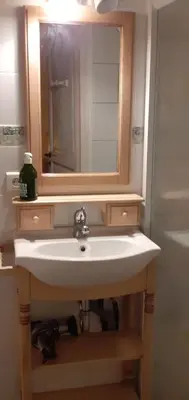 a bathroom with a sink and a mirror at grande terrasse avec vue entre méditerranée et pays cathare in Cailla