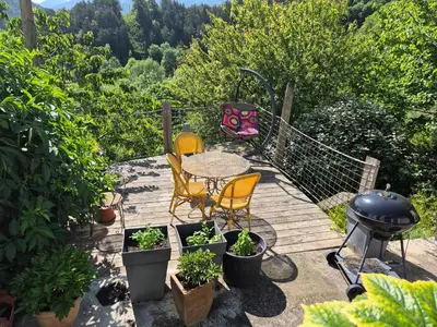 a patio with a table and chairs and a grill at grande terrasse avec vue entre méditerranée et pays cathare in Cailla