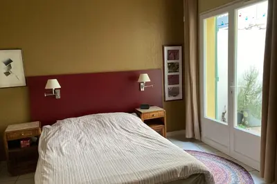 a bedroom with a bed and a window at La Lucquette - House near the Grands Buffets in Narbonne