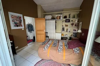 a bedroom with a large bed in a room at La Lucquette - House near the Grands Buffets in Narbonne