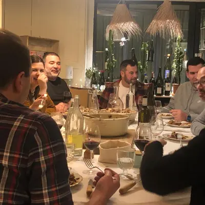 a group of people sitting around a table eating at B&B Vigne Vierge in Aigne