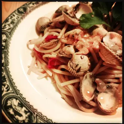 a plate of pasta with mushrooms on a table at B&B Vigne Vierge in Aigne