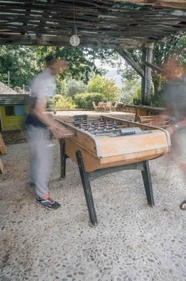 a man standing next to a pool table at Fount Estremiero - Chambres & tables d'hôtes in Castans
