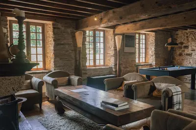 a room with a table and chairs and a pool table at Fount Estremiero - Chambres & tables d'hôtes in Castans