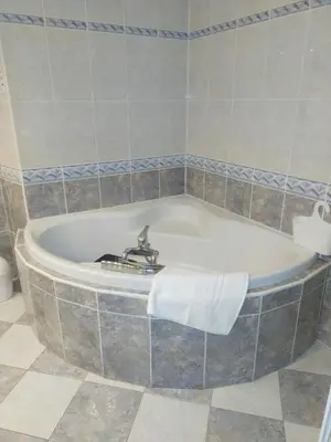 a bath tub with a towel on the side of it at Le Castel d'olmes in Laroque-dʼOlmes