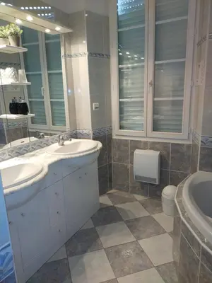 a bathroom with two sinks and a tub and a toilet at Le Castel d'olmes in Laroque-dʼOlmes