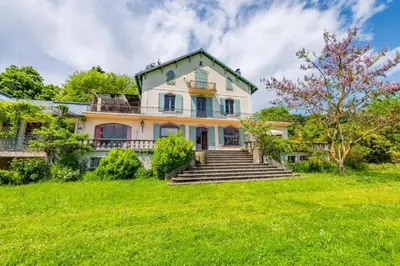 a large white house with stairs in a yard at DEMEURE BERGAMOTE de FONTIERS in Fontiers-Cabardès