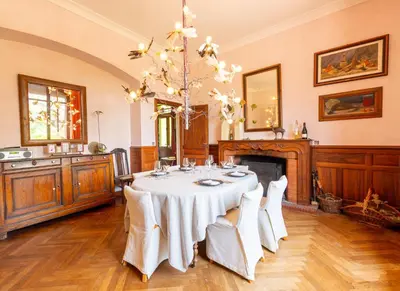 a dining room with a table and a chandelier at DEMEURE BERGAMOTE de FONTIERS in Fontiers-Cabardès