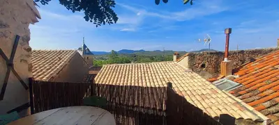 an overhead view of roofs of buildings with a fence at jolie maison avec terrasse in Cessenon