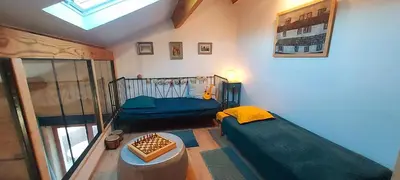 a small room with a bed and a window at jolie maison avec terrasse in Cessenon