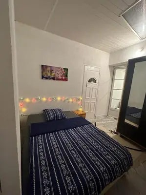 a bedroom with a bed with lights on the wall at Appart T3 centre ville Castres in Castres