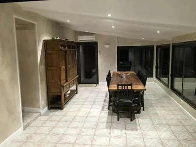 a dining room with a wooden table and chairs at Belle Lauragaise ensoleillée in Issel