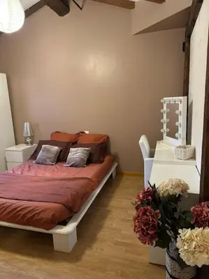 a bedroom with a bed in a room with flowers at Belle Lauragaise ensoleillée in Issel