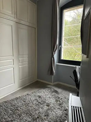 a room with a door and a rug next to a window at Belle Lauragaise ensoleillée in Issel
