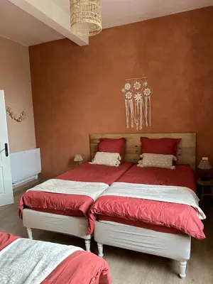 a bedroom with two beds with red and white sheets at Belle Lauragaise ensoleillée in Issel
