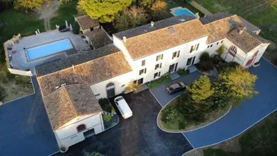an aerial view of a large house with a swimming pool at Belle Lauragaise ensoleillée in Issel