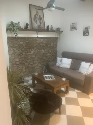 a living room with a couch and a table at Loft ANNEXE de La Villaé in Mazamet