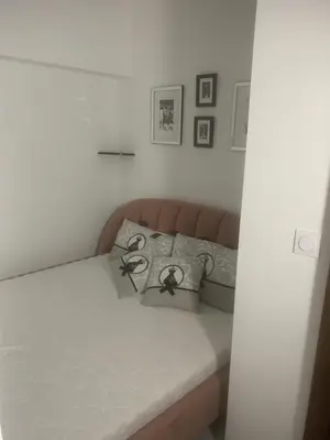a bed with two pillows on it in a bedroom at Loft ANNEXE de La Villaé in Mazamet