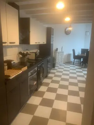 a kitchen with a checkered floor at Loft ANNEXE de La Villaé in Mazamet