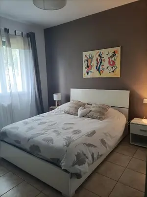a bedroom with a bed with a white bed frame at Chambre calme dans une maison à la campagne in Vielmur-sur-Agout