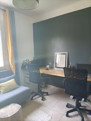 an office with a desk and two chairs and a table at Chambre calme dans une maison à la campagne in Vielmur-sur-Agout