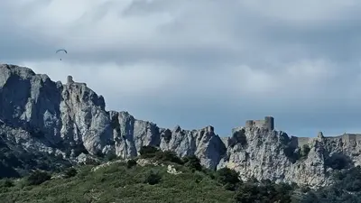 a mountain with a castle on top of it at Gite rue Tranquille in Padern