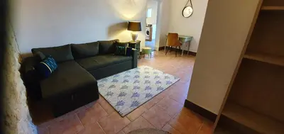a living room with a couch and a table at Maison charmante à Narbonne avec piscine et jardin in Narbonne