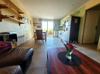 a living room with a vase of flowers on a table at Gîte Le Bel-Estar in Bélesta