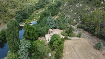 an aerial view of a house next to a river at Le Moulin de La Grave - Lagrasse in Lagrasse