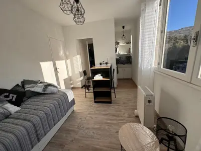 a bedroom with a bed and a desk in a room at Studio Rennes les bains au pied des Thermes in Rennes-les-Bains