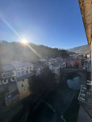 a view of a city with a bridge and a river at Studio Rennes les bains au pied des Thermes in Rennes-les-Bains