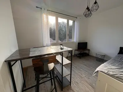 a room with a desk with a chair and a window at Studio Rennes les bains au pied des Thermes in Rennes-les-Bains