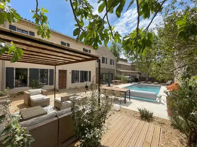 a backyard with a swimming pool and a house at La Feuilleraie in Montséret