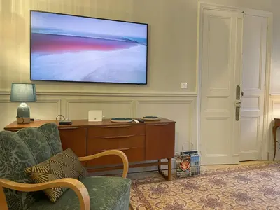 a living room with a flat screen tv on a wall at La Feuilleraie in Montséret