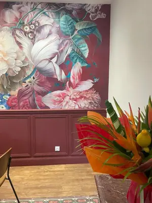 a large painting of flowers on a wall at La Feuilleraie in Montséret