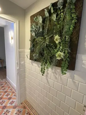 a bathroom with a wall with plants on it at La Feuilleraie in Montséret