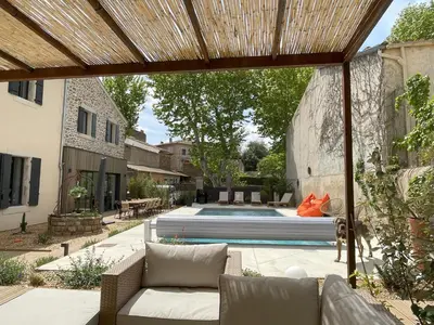 a backyard with a swimming pool and a house at La Feuilleraie in Montséret