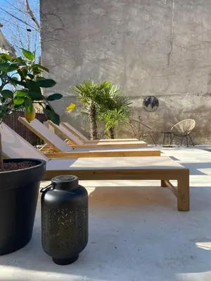 a bench and a vase sitting on a patio at La Feuilleraie in Montséret