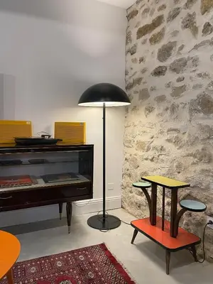 a room with a piano and a table and a lamp at La Petite Ecurie in Montséret