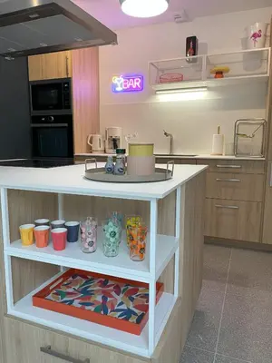 a kitchen with a counter with cups on it at La Petite Ecurie in Montséret