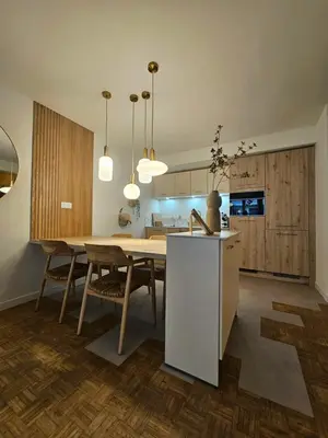 a kitchen and dining room with a table and chairs at LE JACQUARD Appartement Type 2 proche des Halles in Narbonne