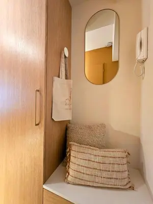 a bathroom with a mirror and a pillow next to a door at LE JACQUARD Appartement Type 2 proche des Halles in Narbonne